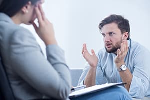 man in LSD addiction treatment speaking to a therapist